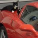Photo of a cat lying on a sports car